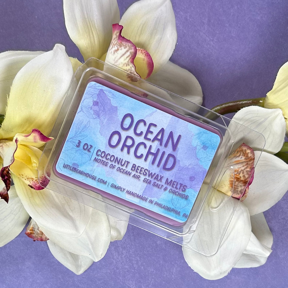 Ocean Orchid scented wax melt atop orchids