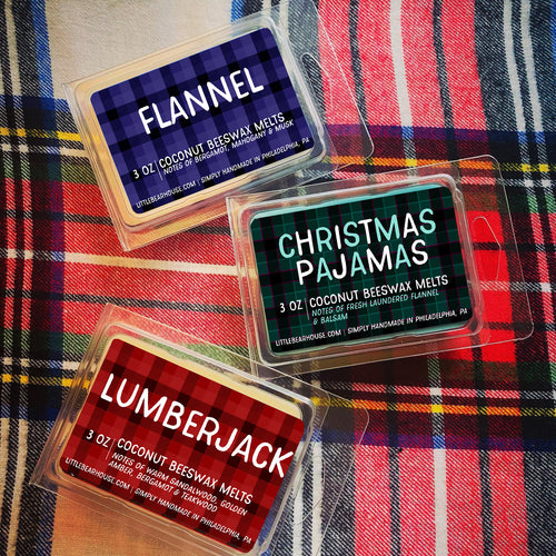 3 oz Flannel, Christmas Pajamas, and Lumberjack beeswax and coconut wax melt on flannel background with a white base and black, blue, red, green, and yellow flannel pattern. Simply handmade in Philadelphia, PA.