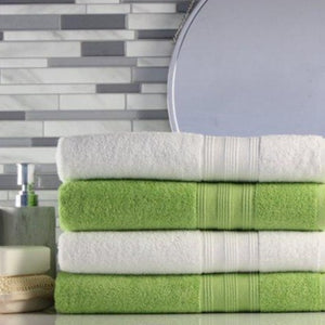 freshly laundered green and white folded towels with a green laundry detergent wax scent