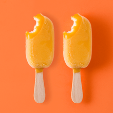 Load image into Gallery viewer, orange and vanilla ice cream pops with a bite taken out of them
