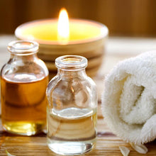 Load image into Gallery viewer, Essential oils on a table at a spa with towel linen and candle wax scent
