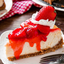 Load image into Gallery viewer, Plate of creamy cheesecake topped with strawberry sauce and whipped cream

