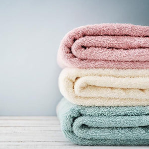 Fresh folded laundry towels washed with fabric softener detergent wax scent
