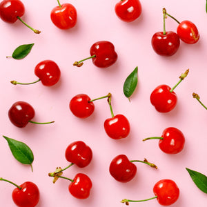 Pink background with bright red maraschino cherries wax scent